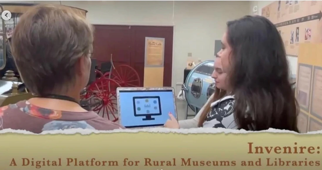 Invenire reviewing their work with a local museum curator
